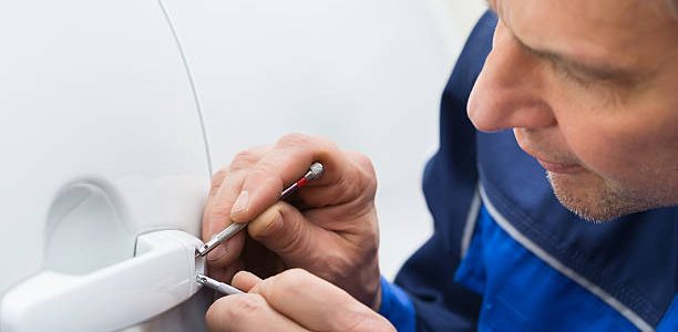Close-up Of Person Hand Holding Lockpicker To Open Car Door car locksmith