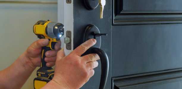 professional locksmith installing a new lock